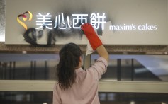 A worker cleans up after vandalism at a Maxim’s cake shop in New Town Plaza, Sha Tin. Photo: Winson Wong