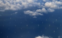 The Burbo Bank Offshore Wind Farm on the Burbo Flats in Liverpool Bay, England, is seen from a plane window. Renewables like wind and solar power can dramatically reduce – by as much as 50 per cent – the carbon dioxide emissions from electricity generation by 2030. Photo: AFP