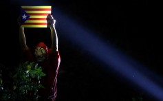 An anti-government demonstrator in Chater Garden, Hong Kong, on October 24 holds a Catalan flag to show solidarity with Catalonia’s independence movement. Photo: Reuters