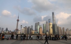 People take in the view of the skyline of Shanghai’s Pudong financial district. China’s increasing integration into the global financial system should lead its asset market returns to become more correlated with global markets – something that is already happening. Photo: AFP