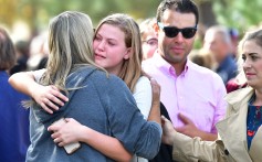 Students and parents embrace after being picked up at Central Park after a shooting at Saugus High School in Santa Clarita, California, on Thursday. Photo: AFP