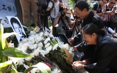Relatives mourn Luo Changqing, who was killed by a brick during clashes between protesters and residents. Photo: Winson Wong