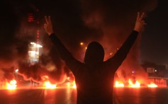 An Iraqi demonstrator gestures as tyres burn during a protest last month in Iraq’s shrine city of Karbala, south of the capital Baghdad. Photo: AFP
