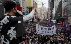 A protesters holds up a hand, to symbolise the movement’s five demands, during a march on New Year’s Day in Causeway Bay. The five demands include democratic elections for Hong Kong’s leader and legislature, and a probe into police behaviour during the six months of protests. Photo: Sam Tsang