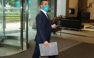 Neil Callan enters HKJC headquarters for his licensing committee hearing. Photos: Kenneth Chan