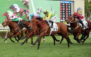Winning Method (outside) sails past Captain Win (blue and pink silks) at Sha Tin on Saturday. Photo: HKJC