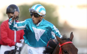 Karis Teetan celebrates winning the Classic Mile aboard Romantic Warrior. Photo: HKJC