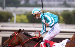 Karis Teetan celebrates winning the BMW Hong Kong Derby aboard Romantic Warrior. Photo: HKJC