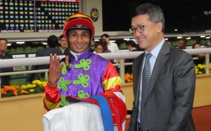 Jockey Karis Teetan celebrates his Happy Valley four-timer with trainer Peter Ho. Photo: Kenneth Chan