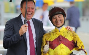 Caspar Fownes and Ellis Wong celebrate the apprentice jockey’s first win, which came aboard Storm Legend at Sha Tin on May 13. Photo: Kenneth Chan
