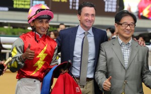 Jockey Karis Teetan and trainer Douglas Whyte celebrate with connections following Majestic Knight’s win at Happy Valley. Photo: Kenneth Chan