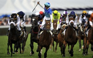 Zac Purton salutes the crowd after winning the Caulfield Cup in 2014. Photo: EPA