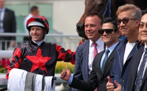 Cantopop star Aaron Kwok (centre) enjoys Dancing Classics’ victory with jockey Hugh Bowman and trainer Caspar Fownes (second from left). Photos: Kenneth Chan