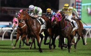Light Years Charm (white, purple and green) gets up to beat Aeris Nova at Sha Tin. Photos: Kenneth Chan