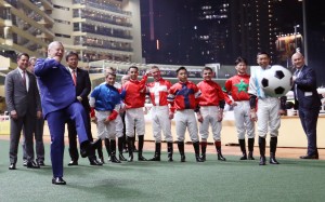 Jockeys watch on as Jockey Club chief executive Winfried Engelbrecht-Bresges (left) shoots for goal before the "Eight To Glory" race at Happy Valley. Photos: Kenneth Chan