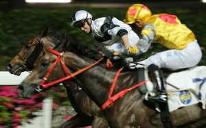 Neil Callan lifts Jolly Convergence to victory at Happy Valley on Wednesday night. Photos: Kenneth Chan