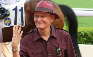Resplendent in a purple safari suit, John Moore celebrates his four-timer. Photos: Kenneth Chan