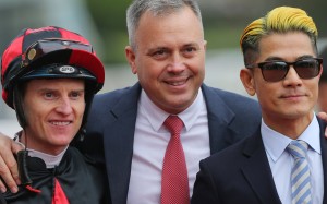 Trainer Caspar Fownes (middle) celebrates the win of Dancing Fighter with jockey Zac Purton (left) and Canto-pop superstar Aaron Kwok (right). Photos: Kenneth Chan