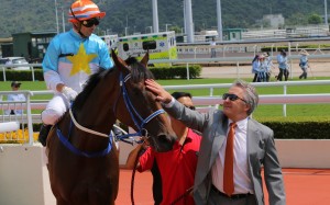 David Ferraris gives Blazing Partners a pat after his win under jockey Umberto Rispoli. Photos: Kenneth Chan