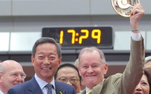 Former Jockey Club chairman Simon Ip presents trainer John Moore with the 2016 Hong Kong Derby spoils after his victory with Werther. Photos: Kenneth Chan
