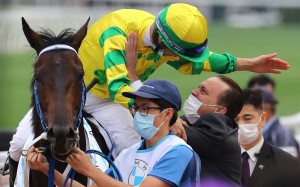 Caspar Fownes and Joao Moreira embrace after winning the BMW Hong Kong Derby with Sky Darci. Photos: Kenneth Chan