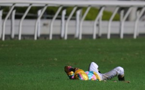 Karis Teetan lies on the turf after a heavy fall at Happy Valley on Wednesday night. Photos: Kenneth Chan