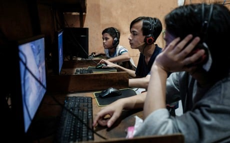 Young men play online games and surf the internet at a cyber cafe in Jakarta last month. Photo: AFP