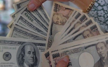 A woman counts US dollars and Japanese yen banknotes in Phnom Penh. Scam money’s reach extends far beyond the Mekong. Photo: AFP