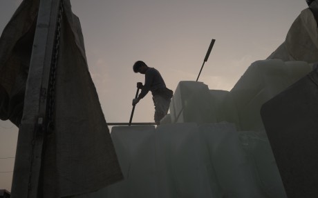 A man on a truck brings the ice that keeps the catch fresh. Photo: Aidan Jones