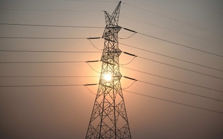 The sun sets behind power lines in San Fernando town, Pampanga province, the Philippines, last month. Photo: AFP