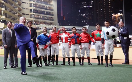 Jockeys watch on as Jockey Club chief executive Winfried Engelbrecht-Bresges (left) shoots for goal before the "Eight To Glory" race at Happy Valley. Photos: Kenneth Chan