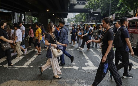 People cross a road in Manila, the Philippines, on September 8. Photo: EPA