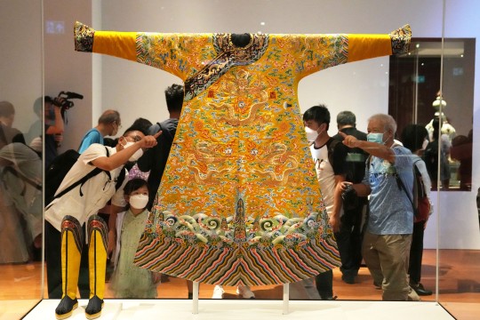 A lavish robe for men with motifs of dragons, clouds and bats woven into its design, on display at the Hong Kong Palace Museum. Photo: Sam Tsang