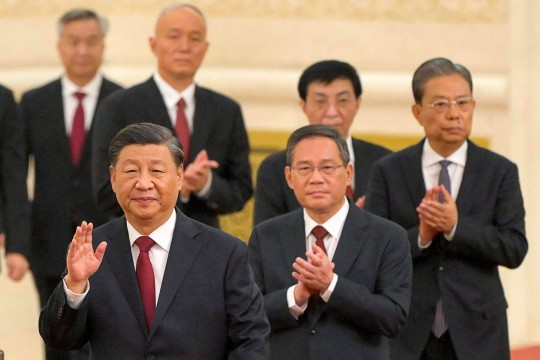 Chinese President Xi Jinping (front) walks with members of the country’s new Politburo Standing Committee. Photo: AFP