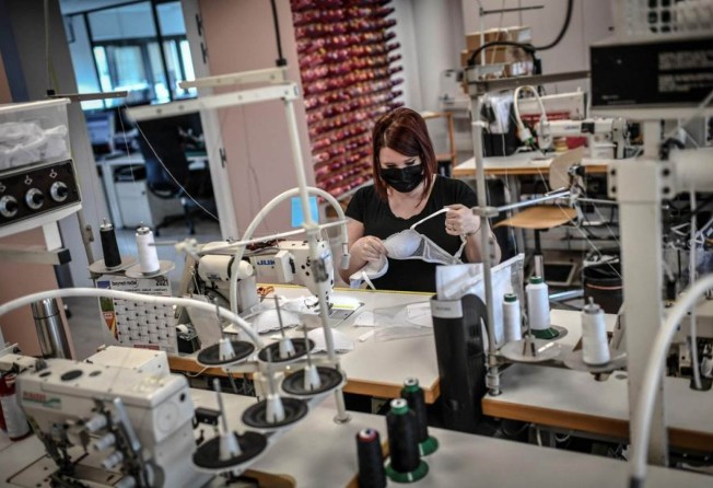 A seamstress works at the Simone Perele headquarters in Clichy. Photo: AFP