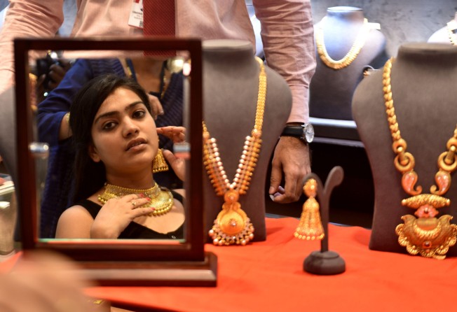 A woman buying gold on the occasion of Akshaya Tritiya, an annual spring time festival of the Hindus and Jains. Photo: Getty Images
