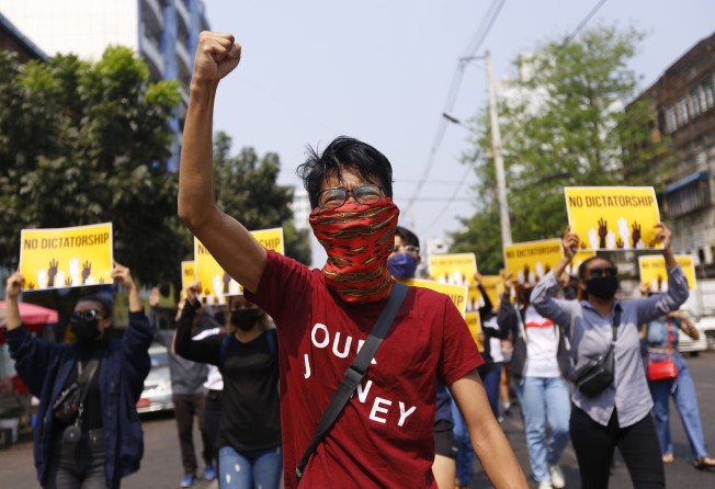 Anti-coup protesters gesture during a march in Yangon on March 26. Photo: AP