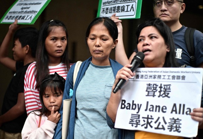 Baby Jane Allas (centre) stands with family members and supporters after a hearing at the Labour Tribunal in Hong Kong on April 15, 2019. Photo: AFP 