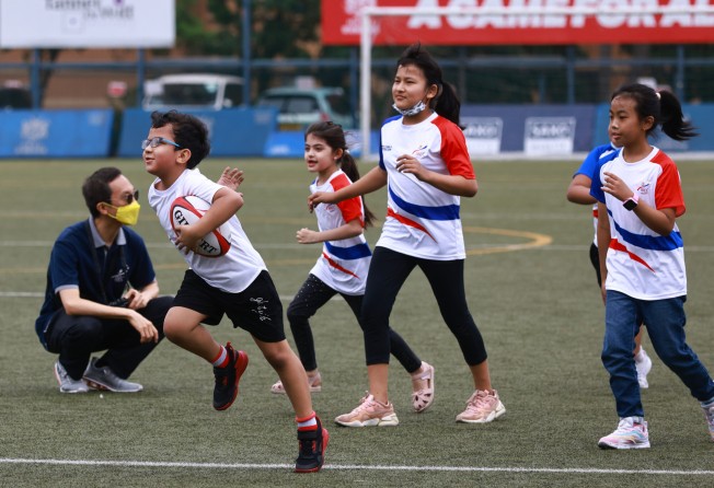 Young ethnic minority students playing trial rugby games with HKRU coaches at King’s Park in April. Photo: SCMP/May Tse 