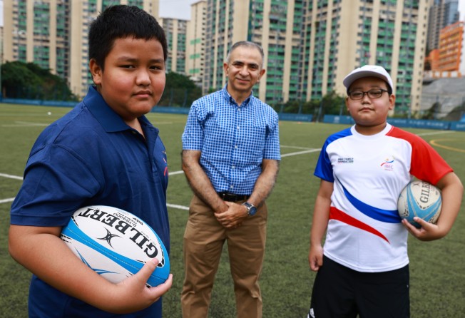 IBEL student Aris Gurung (left), school CEO and co-founder Manoj Dhar and student Abhi Limbu with rugby balls at King’s Park rugby pitches in Jordan in April. Photo: SCMP/May Tse