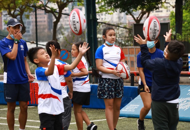 Students from IBEL learning about rugby from HKRU player-coaches during a rugby fun day at King’s Park, Jordan. Photo: SCMP/May Tse