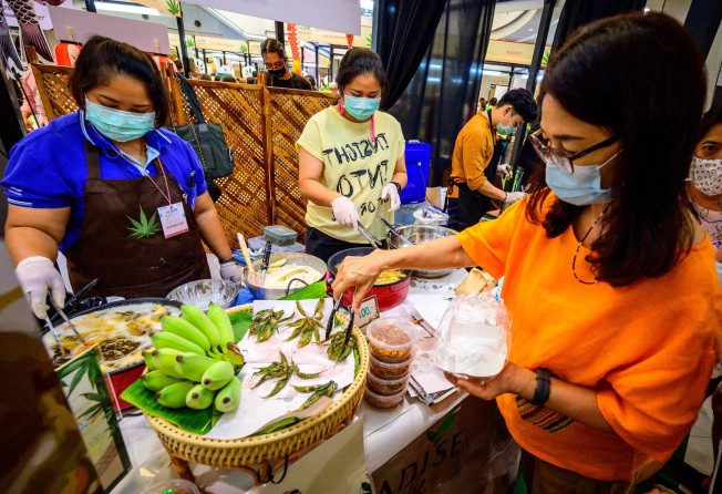 A customer buys fried cannabis leaves at a trade fair in Bangkok. Photo: AFP 