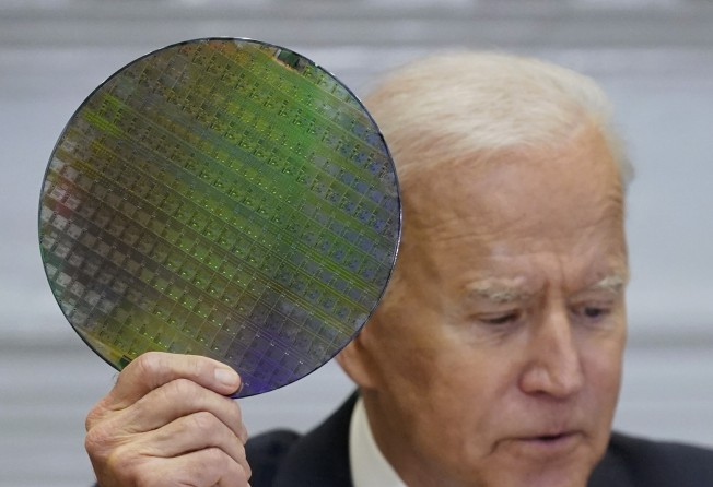 US President Joe Biden holds up a silicon wafer, as he participates virtually in the CEO Summit on Semiconductor and Supply Chain Resilience in the Roosevelt Room of the White House, on April 12, 2021, in Washington. Photo: AP