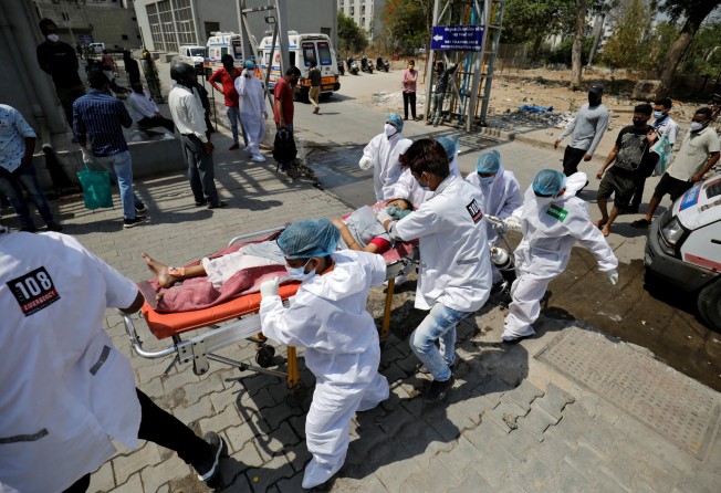 A Covid-19 patient is taken into hospital for treatment in Ahmedabad, India. Photo: Reuters