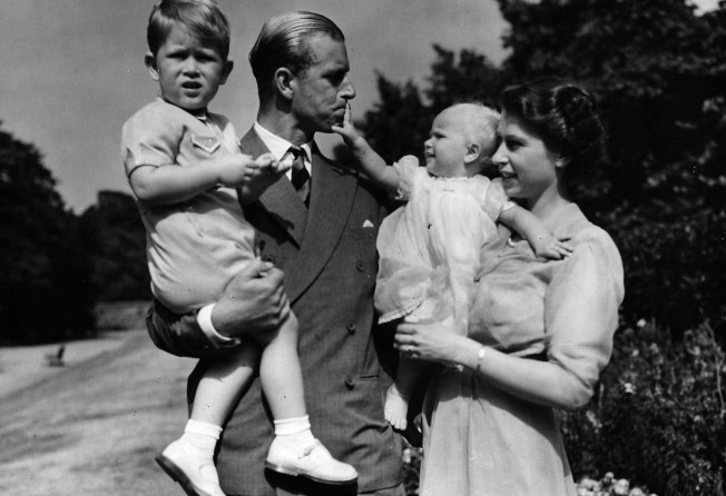 In this photograph from 1951, Princess Elizabeth stands with Prince Philip and their children Prince Charles and Princess Anne at Clarence House. Photo: AP