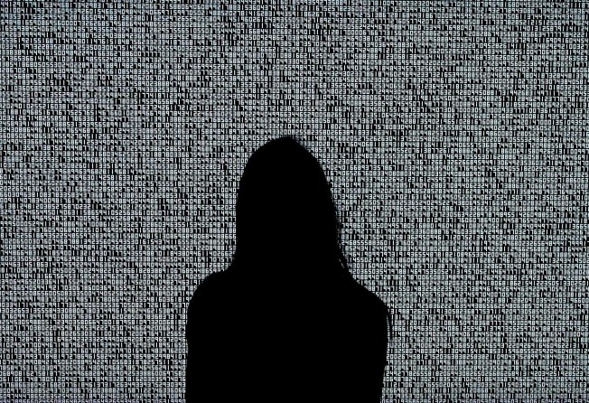 A woman looks at a NFT by Ryoji Ikeda titled “A Single Number That Has 10,000,086 Digits” during a media preview on June 4, 2021, at Sotheby’s. Photo: AFP