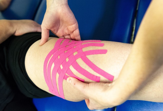 Brightly coloured elastic therapeutic tape, which is made of cotton, synthetic and adhesive is also known as kinesiology tape. Photo: Getty Images