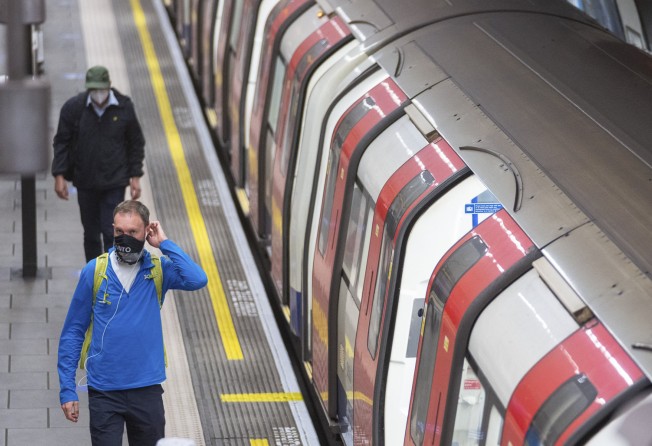 Commuters at a London Underground station. A headset manufacturer firm has called on people to step away from their headphones for one day. Photo: Getty Images