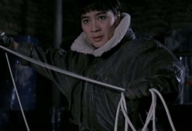 Yeoh, clad in a leather flying jacket, in a still from Magnificent Warriors (1987).