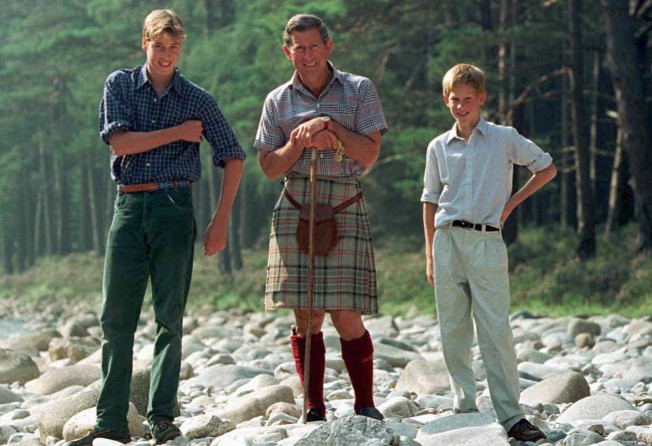 The Prince of Wales poses for photographers with his two sons, Prince William and Prince Harry, on the banks of the River Dee at the start of their summer holiday at Balmoral, in August 1997. Photo: Reuters